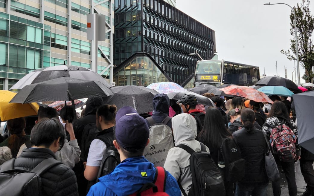 Students waiting for a bus outside AUT on 9 May, 2023.