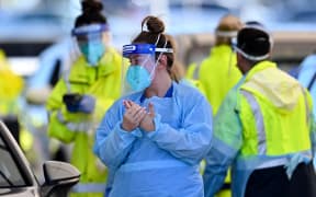 Health workers conduct Covid-19 tests at the St. Vincents Hospital drive-through testing clinic at Bondi Beach in Sydney 27 June, 2021.