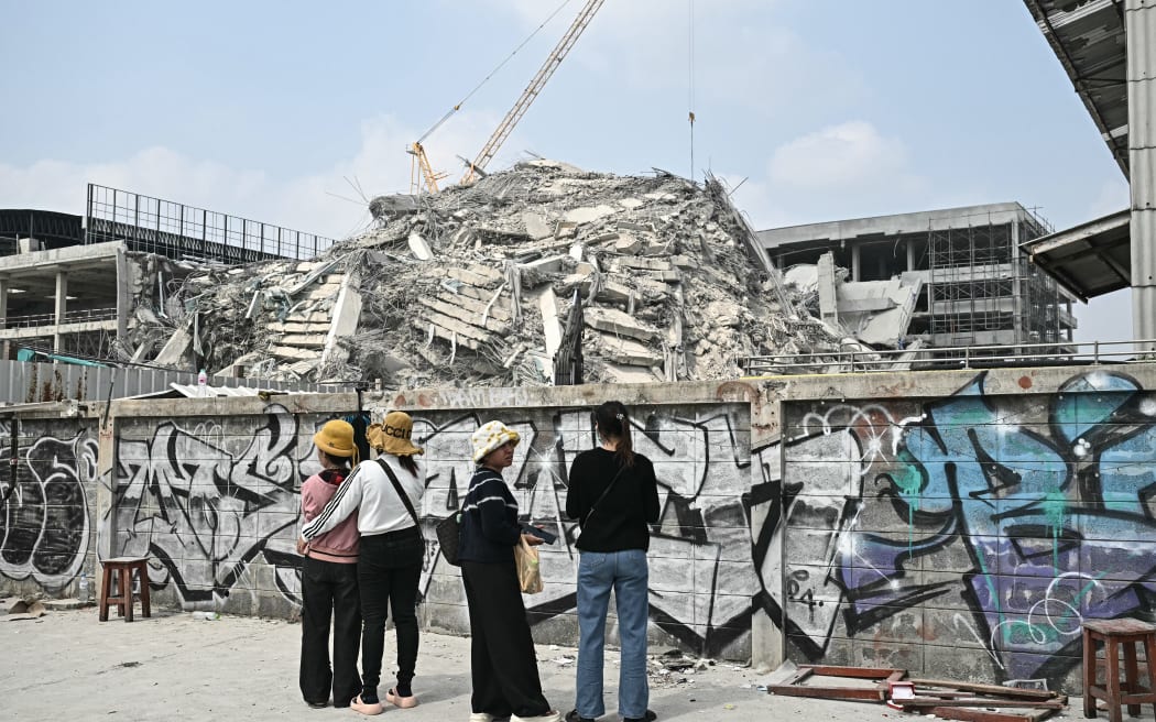 Friends and relatives wait for news about possible survivors at the site of an under-construction building collapse in Bangkok on 29 March, 2025, a day after an earthquake struck central Myanmar and Thailand.