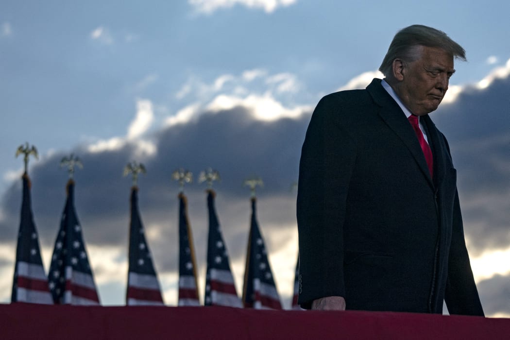 Former US president Donald Trump addresses guests at Joint Base Andrews in Maryland on January 20, 2021.