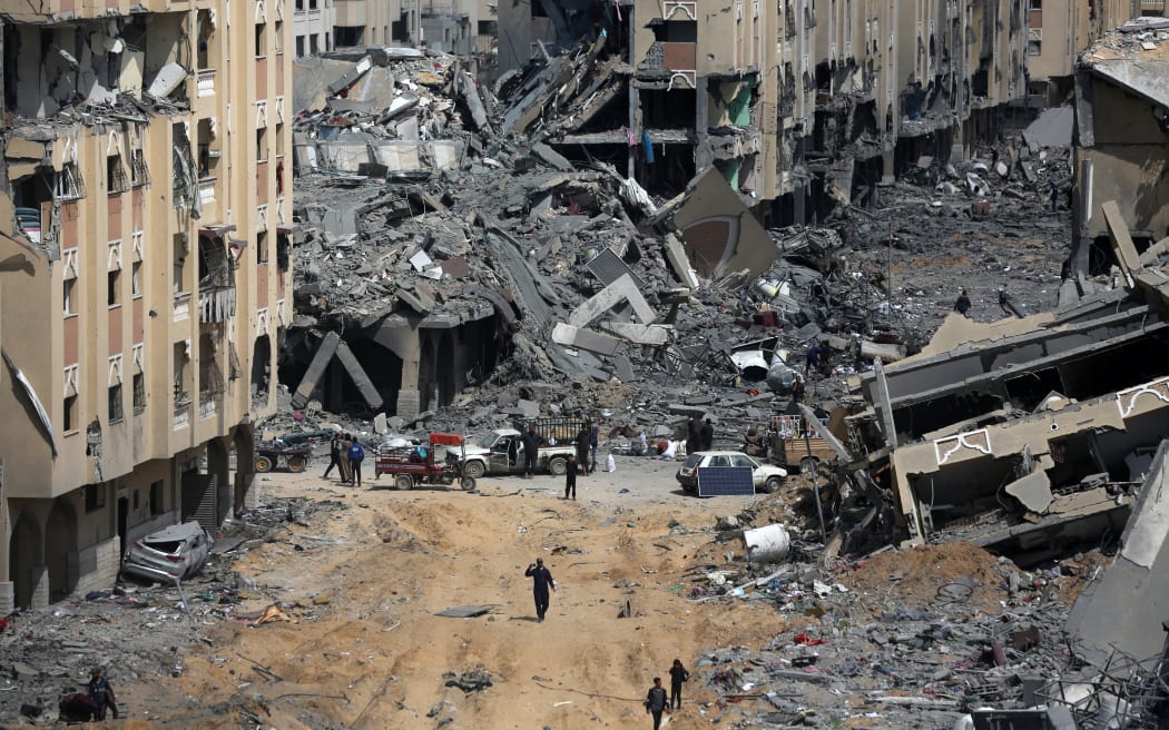 A Palestinian man is walking past the rubble and inspecting the damages in Qatari-funded Hamad City, following an Israeli raid, amid the ongoing conflict between Israel and Hamas in Khan Younis in the southern Gaza Strip on 14 March 14, 2024.