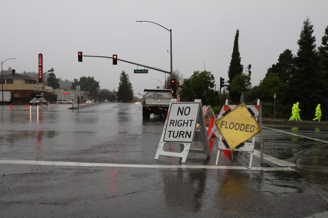 Warning signs near a flooded area in the San Francisco Bay Area on 11 December 2014 (local time).