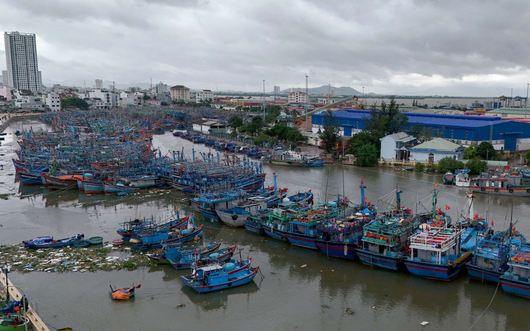 An aerial photo shows dark clouds over Quy Nhon fishing port as fishermen prepare vessels for the impact of Typhoon Kalmaegi in Gia Lai province in central Vietnam.
