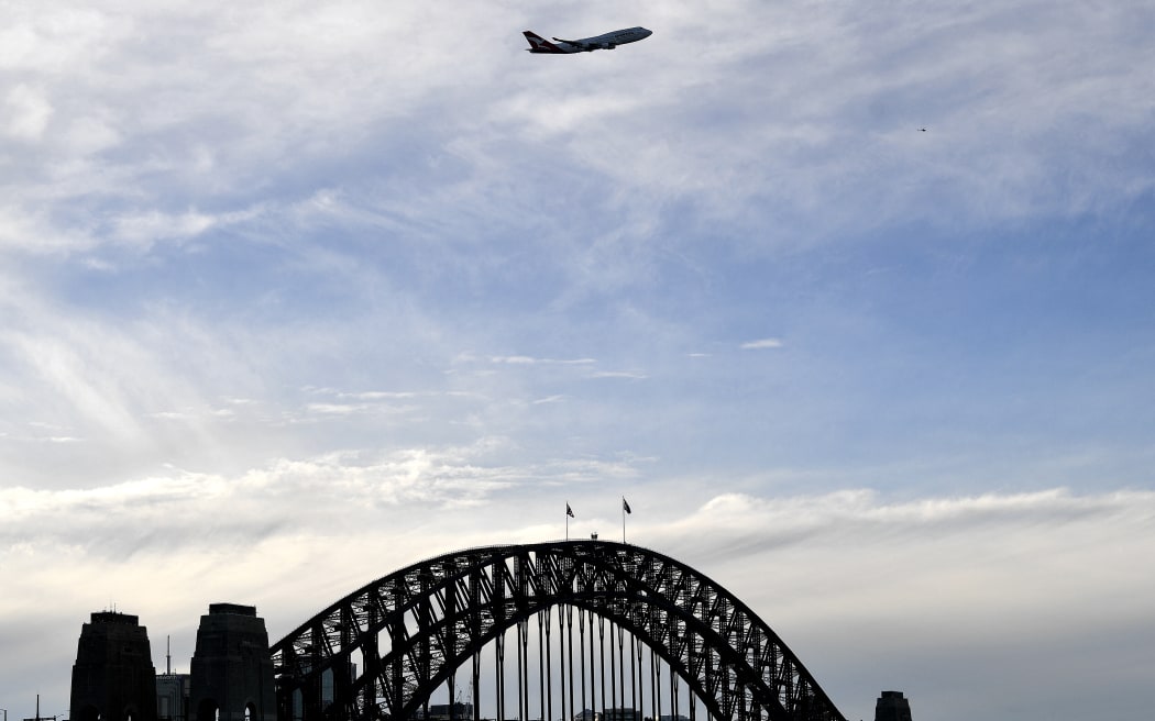 The last Qantas Boeing 747 airliner flies over the Sydney Harbour Bridge during its farewell flight to the US on July 22, 2020.