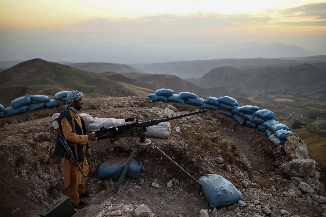 An Afghan militia fighter keeps a watch at an outpost against Taliban insurgents at Charkint district in Balkh Province on 11 July, 2021.