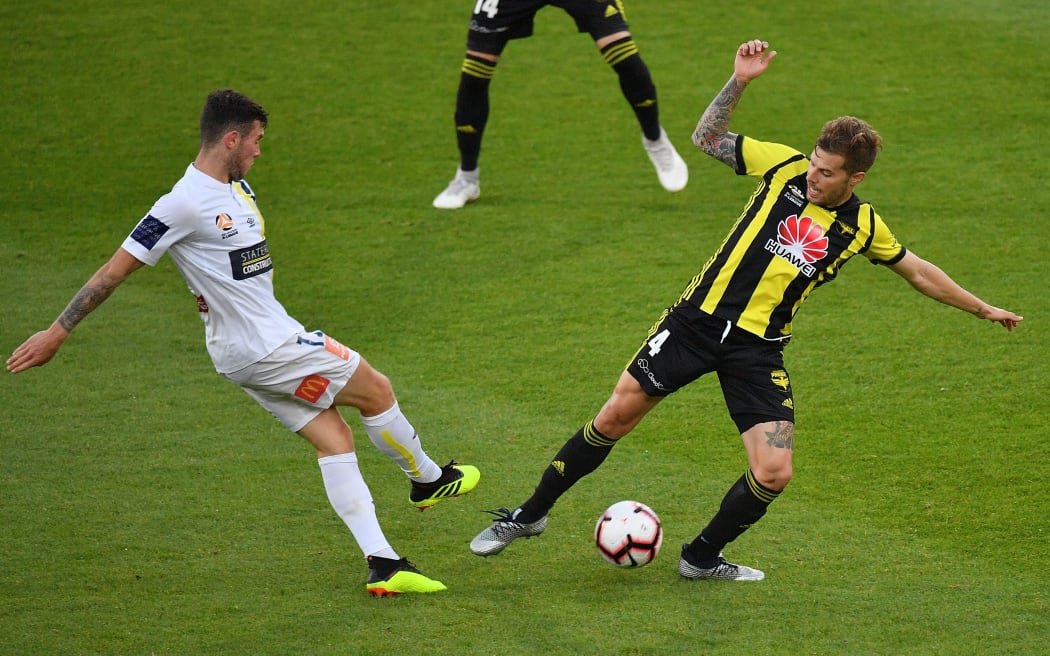 Phoenix player Mandi fights for possession against the Central Coast Mariners earlier this season.