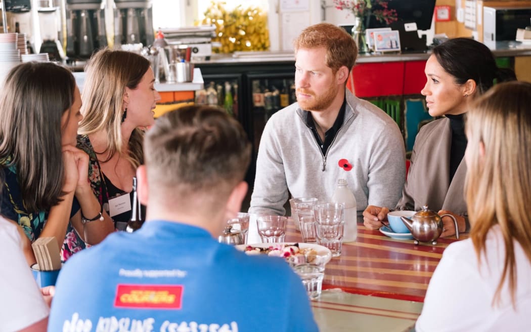 Prince Harry and Meghan, Duchess of Sussex, talk to Jazz Thornton and Gen Mora, founders of Voices of Hope at Maranui Cafe in Wellington.