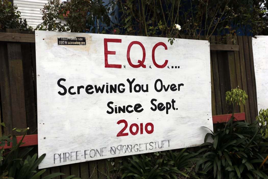 Protest signs on houses after the earthquakes.
