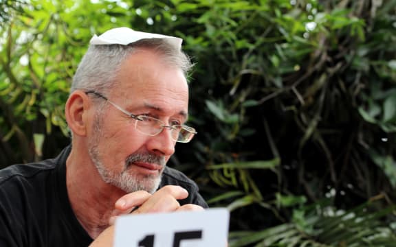 Peter Ellis, sitting at a cafe with a napkin on his head