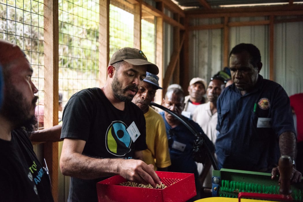 Will Valverde of Fairtrade demonstrates wet mill at Neknasi.