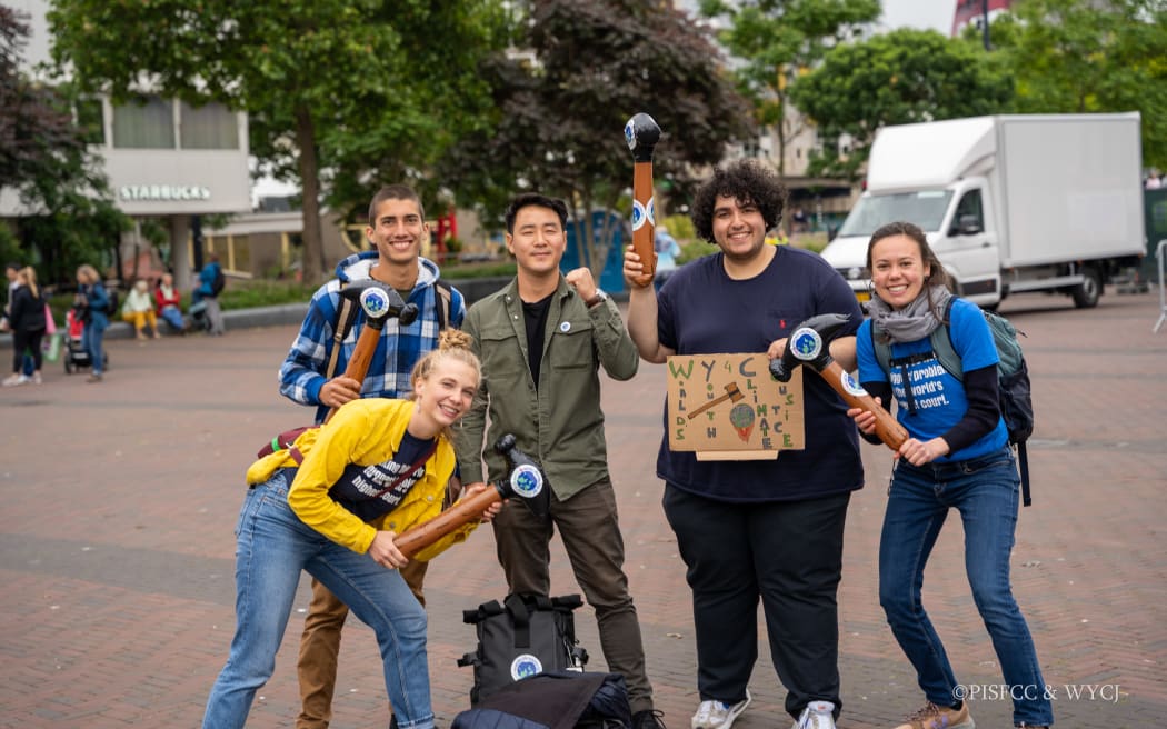 Solomon Yeo of the Pacific Islands Students Fighting Climate Change, standing second left, with youth climate activists.