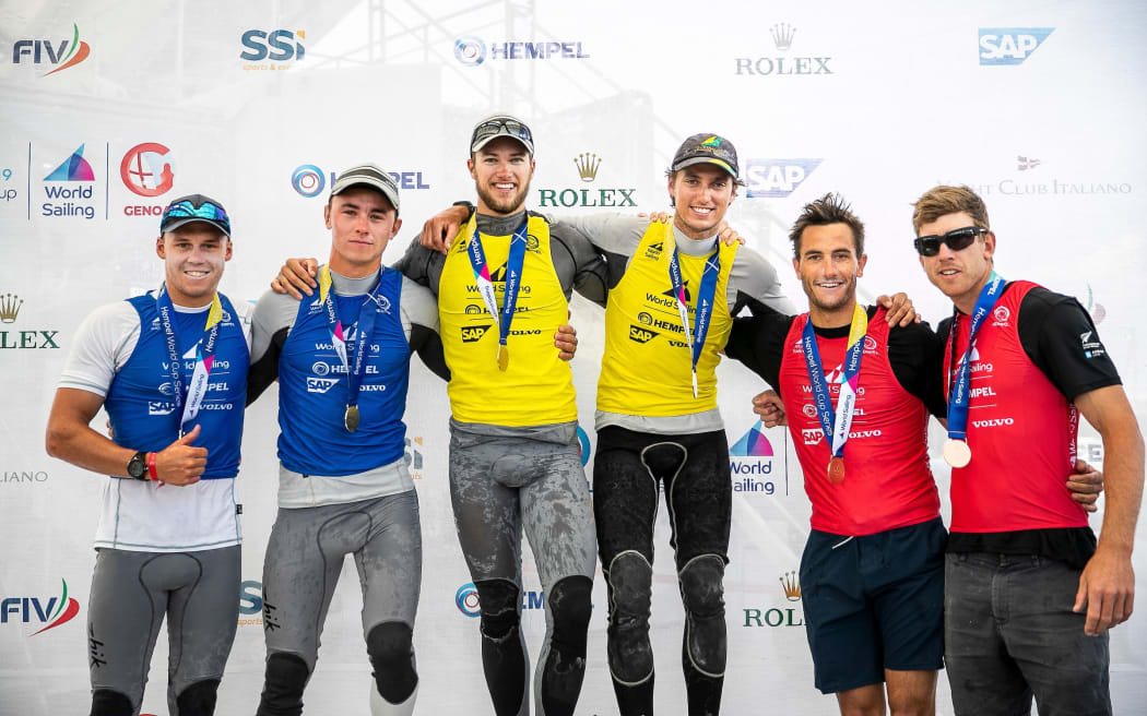 Isaac McHardie and William McKenzie (L) win silver, David and Lachy Gilmour (C) win gold, Blair Tuke and Peter Burley (R) win bronze in the 49er