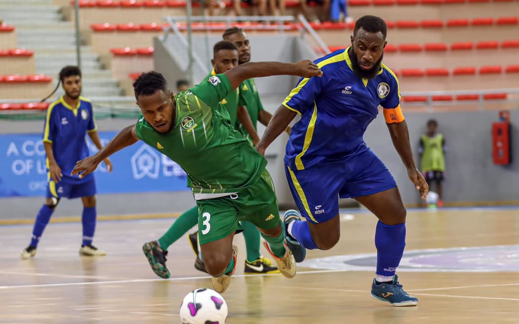 Mataks FC's Geoffrey Lema (left) and AS PTT's James Namuli fight for possession at the OFC Futsal Men's Champions League 2024 in Noumea on Thursday 25 April 2024. Photo: Shane Wenzlick / www.phototek.nz