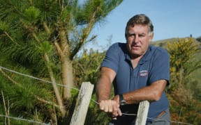 Ex-All Black Colin Meads at his farm in Te Kuiti as he stands beside the Pine Tree that grows on his property, 15 May, 2002
