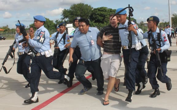 Matt Lockley being arrested by Indonesian Air Force soldiers.