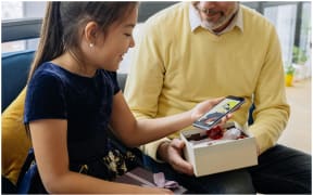 Image of girl receiving smartphone gift