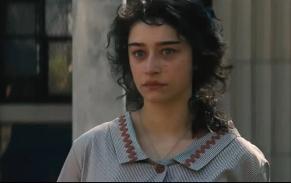 Odessa A'zion is a young, dark-haired woman who wears a grey blouse and looks sad.