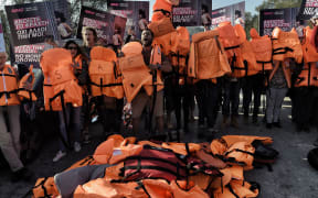 Activists demonstrate during a visit to Lesbos of Alexis Tsipras and European Parliament President Martin Schulz (not pictured).