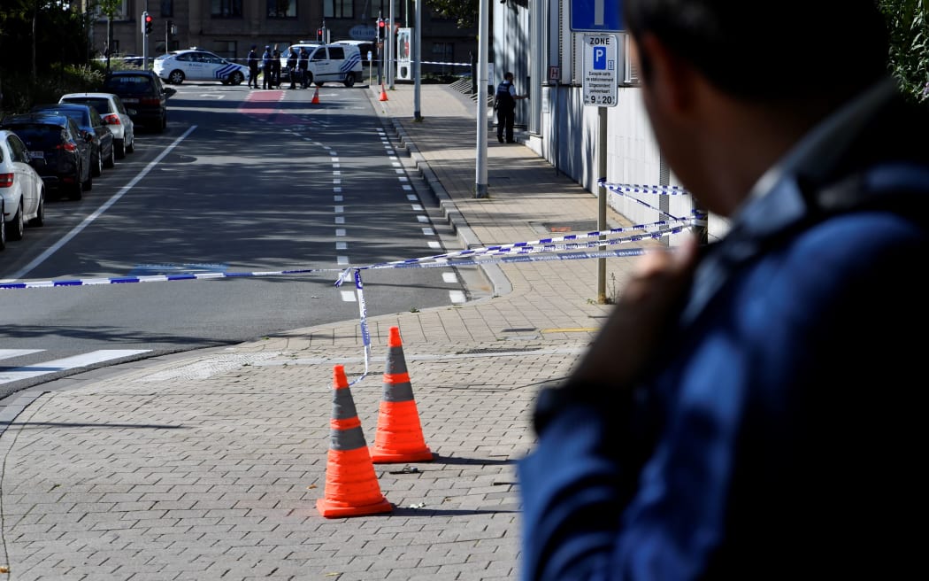 Police set up a security perimeter around the scene where police officers were stabbed in the Schaerbeek neighbourhood in Brussels.
