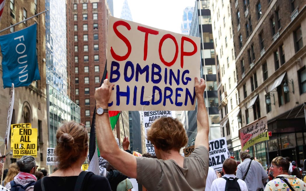 People take part in a march against Israeli Prime Minister Benjamin Netanyahu as he addresses the United Nations General Assembly in New York on September 26, 2025. Netanyahu aggressively ruled out Palestinian statehood in a speech to the UN Friday telling those delegates who stayed to listen that it would be tantamount to "national suicide" for his country. "Israel will not allow you to shove a terrorist state down our throats. We will not commit national suicide because you don't have the guts to face down the hostile media and antisemitic mobs demanding Israel's blood," he said. (Photo by kena betancur / AFP)