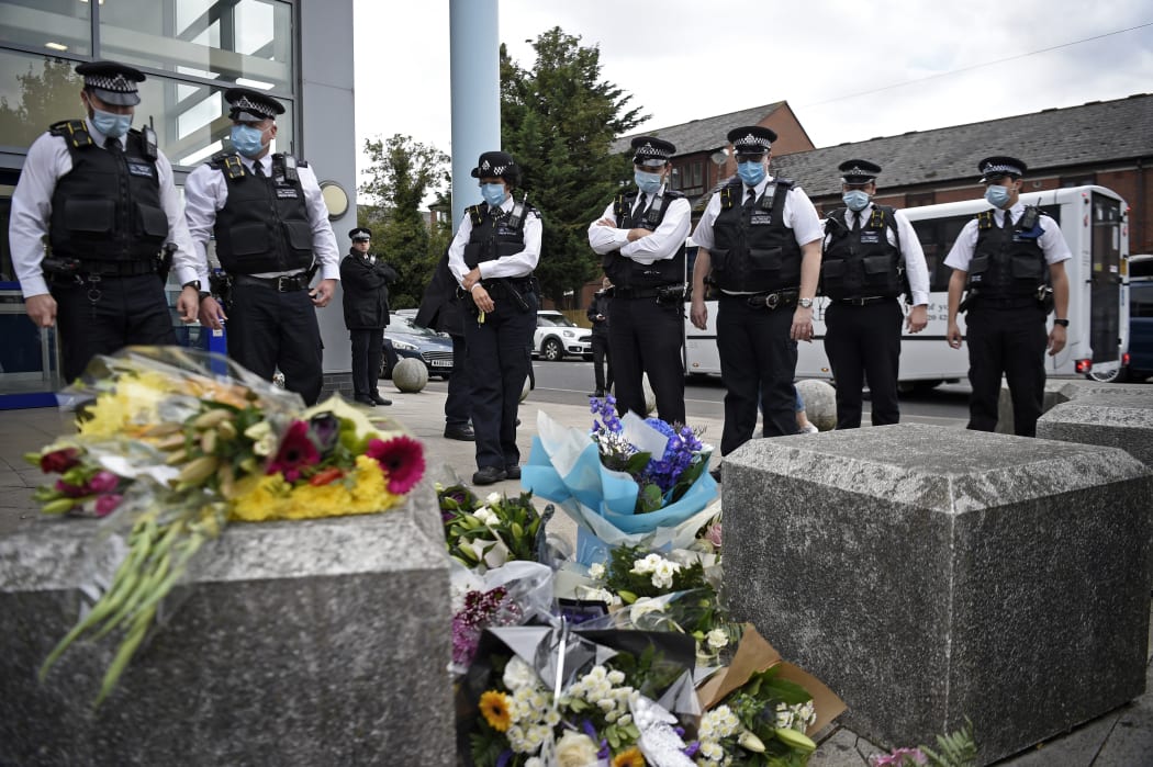 Police officers wearing protective face masks, pay their respects outside the Croydon Custody Centre in south London on 25 September 2020 following the shooting of a British police officer, reported to be a NZer by a 23-year-old man, being detained at the centre.