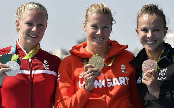 (L-R) Denmark's Emma Jorgensen, Hungary's Danuta Kozak and New Zealand's Lisa Carrington celebrate on the podium after the Women's Kayak Single (K1) 500m event at the Lagoa Stadium during the Rio 2016 Olympic Games in Rio de Janeiro on August 17, 2016.