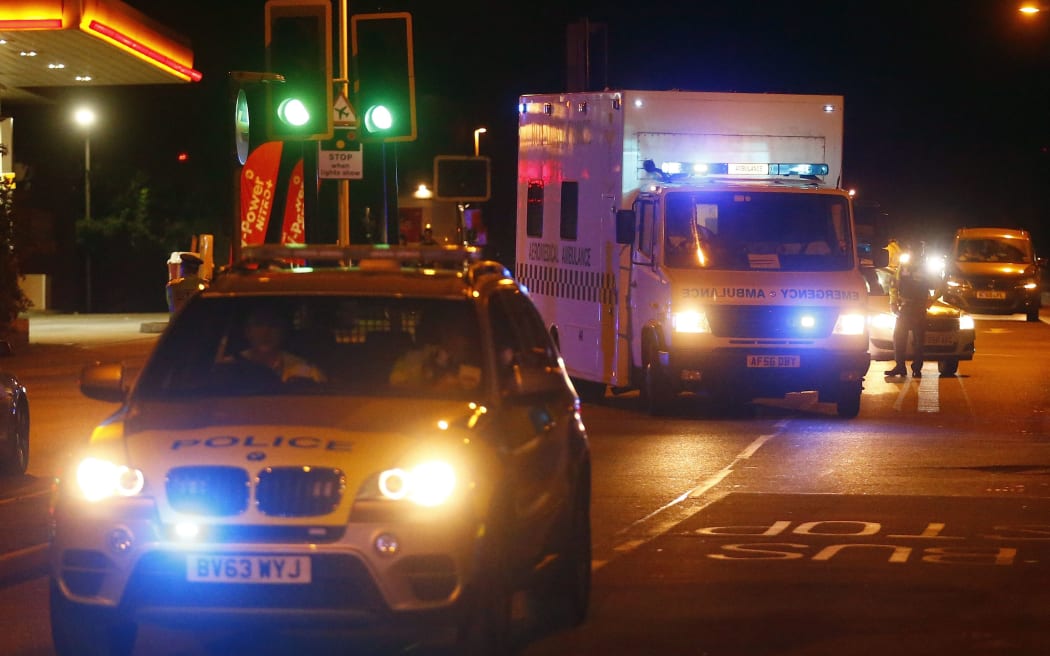 Police escort an RAF ambulance carrying a British man infected with the Ebola virus at Northolt air base outside London.