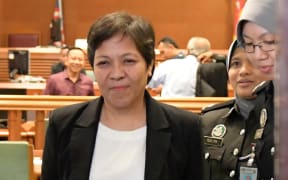 Maria Elvira Pinto Exposto is escorted from the High Court after being cleared of drug trafficking charges in Shah Alam, outside Kuala Lumpur.