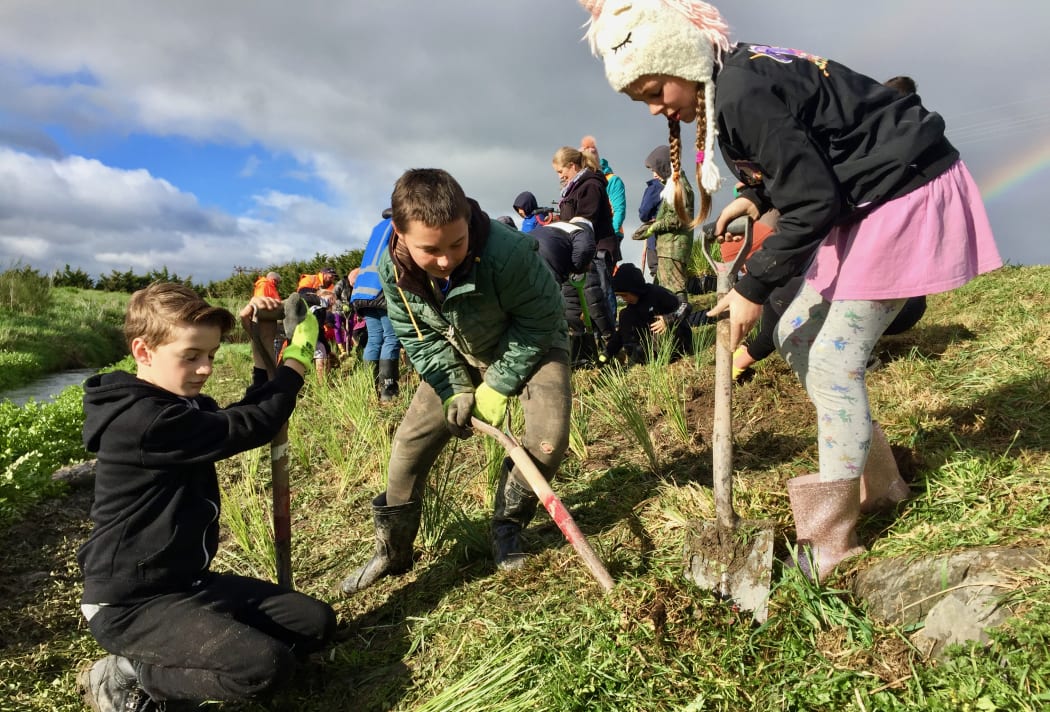 Students from Featherston's St Teresa's School working on a creek restoration project, funded by Greater Wellington Regional Council. GWRC recently approved consent for a quarry further upstream.