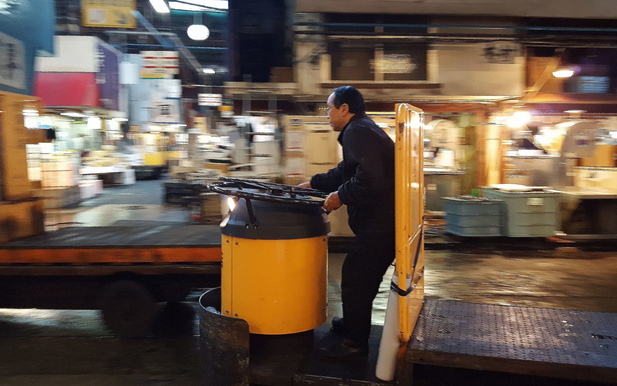 Small goods vehicle in busy early morning market.