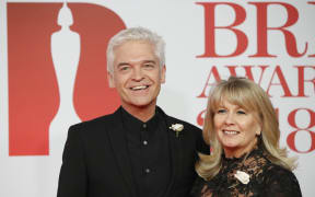 British television presenter Phillip Schofield and his wife Stefanie Lowe, at the BRIT awards in 2018.