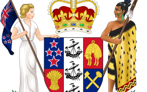 Coat of Arms of New Zealand (1956-Present)
The Coat of Arms depict a shield with four quadrants divided by a central "pale". The first quadrant depicts the four stars on the flag of New Zealand; the second quadrant depicts a golden fleece, representing the nation's farming industry; the third depicts a sheaf of wheat for agriculture; and the fourth quadrant depicts crossed hammers for mining. The central pale depicts three galleys, representing New Zealand's maritime nature and also the Cook Strait. The Dexter supporter is a European woman carrying the flag of New Zealand, while the Sinister supporter is a Maori Warrior holding a Taiaha (Fighting weapon) and wearing a Kaitaka (flax cloak). The Shield is topped by the Crown of St. Edward, the Monarch of New Zealand's Crown. Below is a scroll with "New Zealand" on it, behind which (constituting the "heraldic compartment" on which the supporters stand) are two fern branches.