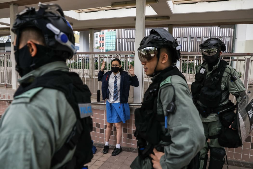 A school student is questioned by police in the Sai Wan Ho district in Hong Kong on November 12, 2019 following a day of pro-democracy protests.