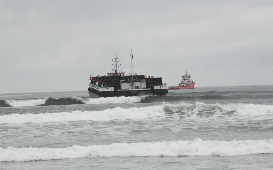The Manahau sand barge being towed off Westport’s Carters Beach