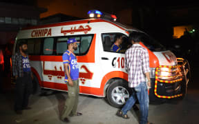 Volunteers transport Sabeen Mehmud's body after she was shot in Karachi.
