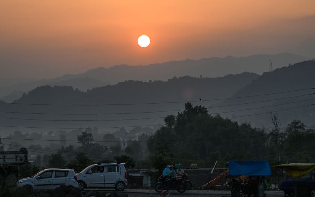 The sun sets over the main town of Poonch district in the Jammu region on May 6, 2025. (Photo by Punit PARANJPE / AFP)