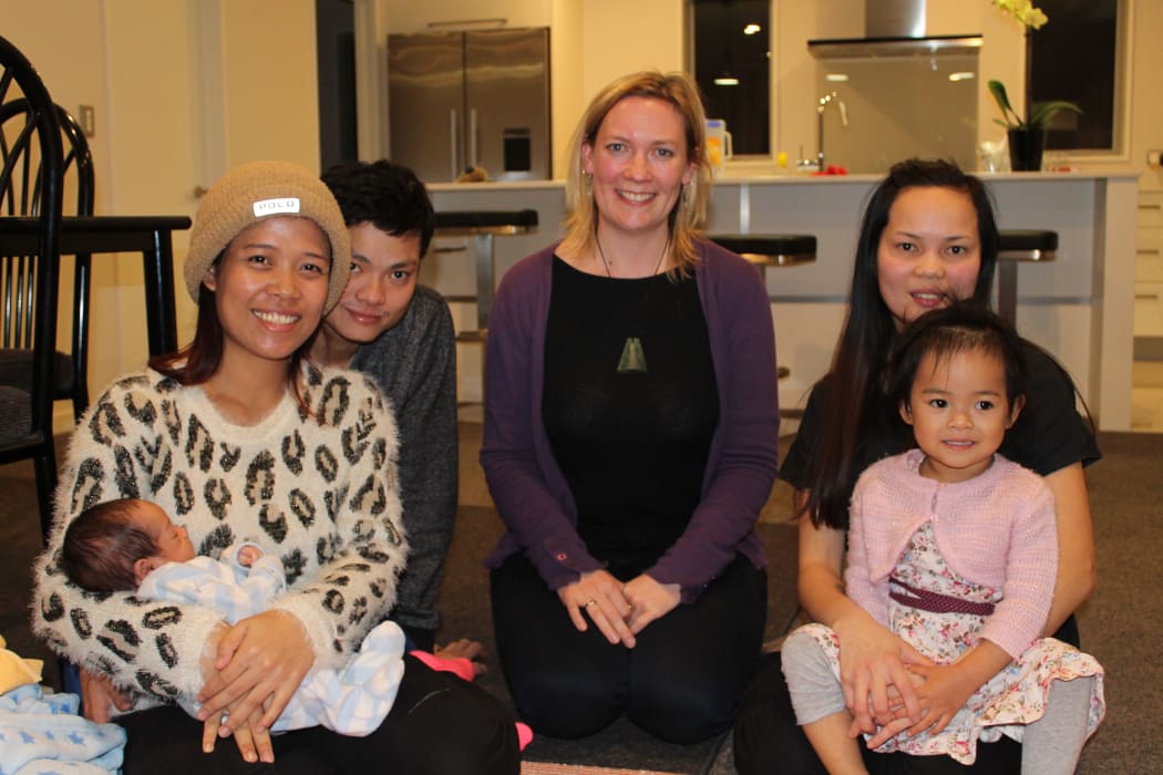 A photo of Vanny Yun with baby Sondra, her husband Sally Yen, their midwife Cara Meredith and Houng Yen holding Vanny and Sally's daughter, Sonila.