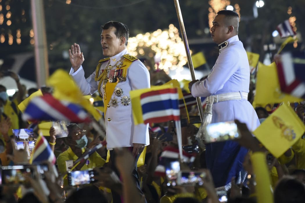Thai King Maha Vajiralongkorn greets supporters as he walks to participate in a candle lighting ceremony in remembrance of late Thai King Bhumibol Adulyadej's birthday anniversary at Sanam Luang in Bangkok, Thailand, 05 December 2020.