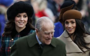 (L-R) Britain's Catherine, Duchess of Cambridge, Britain's Prince Philip, Duke of Edinburgh and US actress and fiancee of Britain's Prince Harry Meghan Markle (R) arrive to attend the Royal Family's traditional Christmas Day church service.