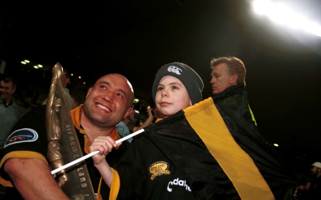 Wellington's Norm Hewitt poses for a photo with a young fan at the NPC rugby union Final between Wellington and Canterbury, on October 21 2000. Photo: Dean Treml/PHOTOSPORT