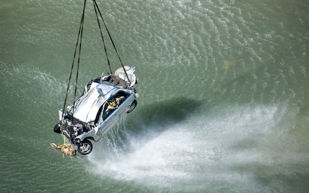 A Royal New Zealand Air Force NH90 helicopter works with a police dive team to recover a car from the Mohaka River.