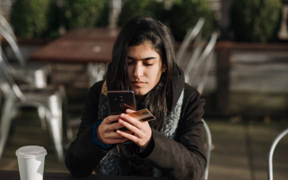 woman on phone with credit card