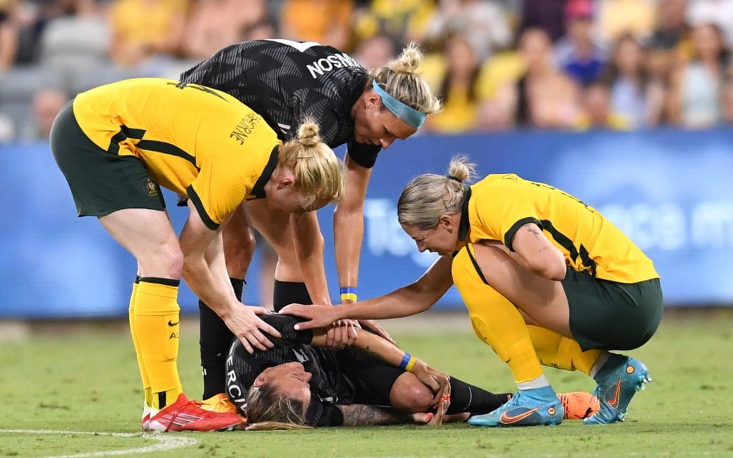 An injured Ria Percival of New Zealand is consoled.