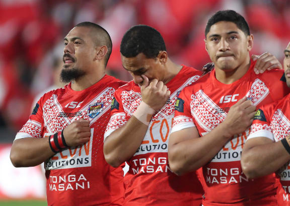 Sika Manu, Will Hopoate and Jason Taumalolo during the Tonga national anthem prior to kickoff against the Kangaroos.