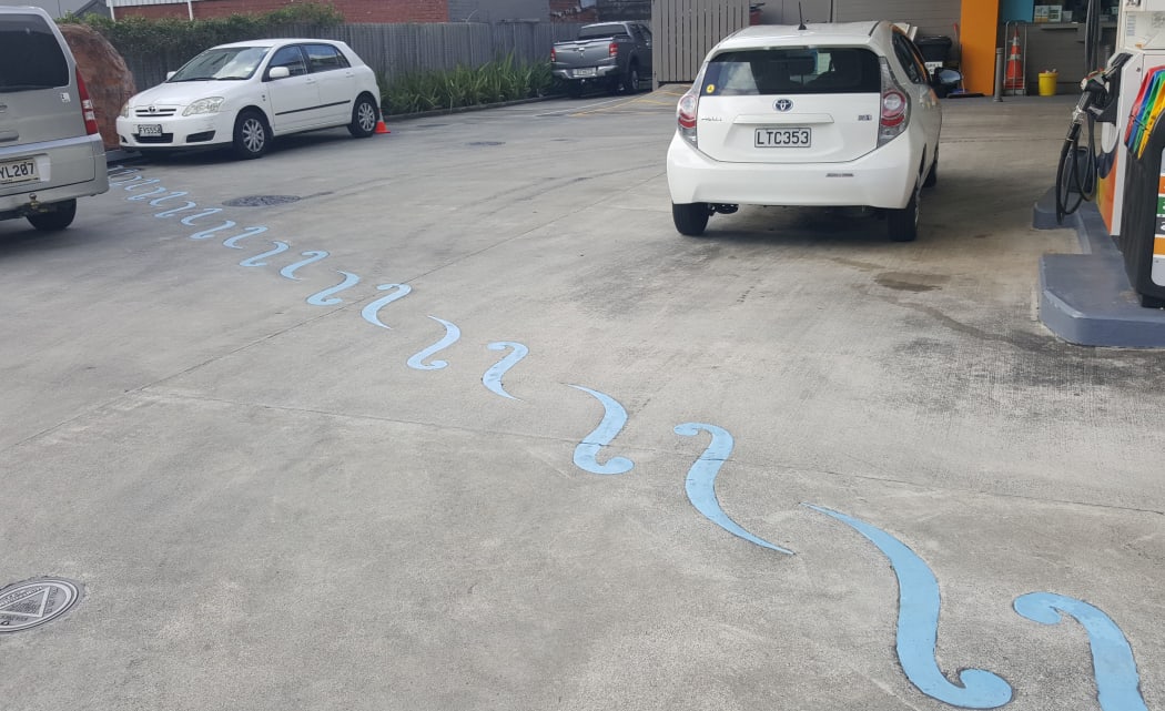 The route of the Waimapihi Stream, which starts in the Aro Valley and runs underground through central Wellington, is marked out on a service station forecourt.
