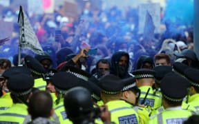 Police form a line to prevent protesters entering King Charles Street, near Whitehall in central London, 7 June 2020.