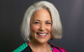 Susana Lei'ataua smiling in front of grey background