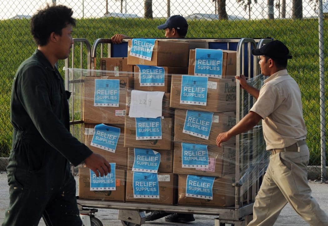 Crew members of Royal Caribbean International's Mariner of the Seas offload 20,000 meals prepared for Hurricane Dorian victims on September 7, 2019 in Freeport, Bahamas.