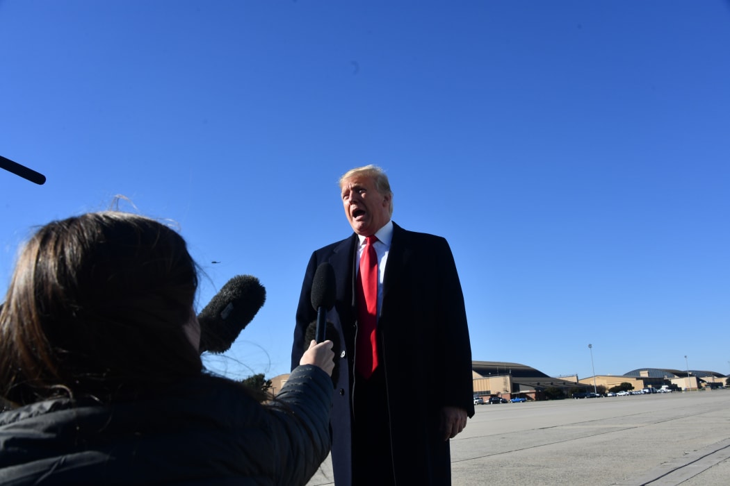 US President Donald Trump speaks to reporters.