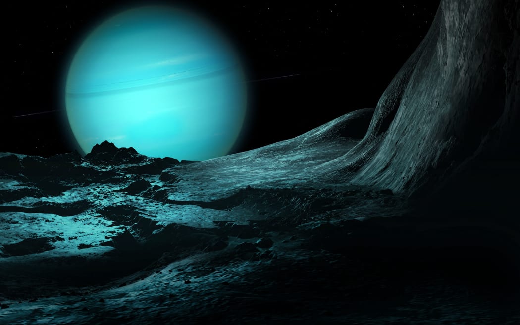 Illustration of the green ice giant planet Uranus, seen from the surface of its innermost substantial moon, the fractured Miranda. Uranus is the seventh planet in order of distance from the Sun, orbiting at an average distance of 2.85 billion km. It is unusual in that it has a very pale, almost featureless atmosphere, and an axial tilt close to 100 degrees. Miranda’s odd surface, including the highest cliff in the known solar system, suggests that the world was broken apart in a collision and later reassembled. (Photo by MARK GARLICK/SCIENCE PHOTO LIBRA / MGA / Science Photo Library via AFP)